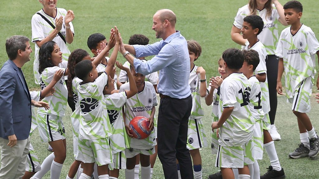 William plays football with children at iconic Maracana stadium