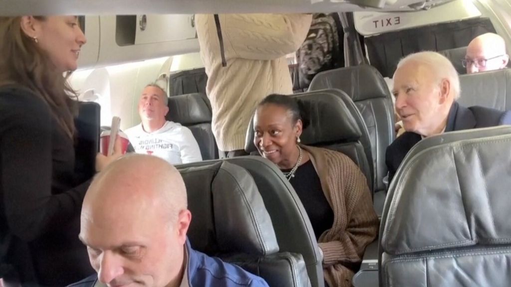 Joe Biden takes selfies with passengers as he takes commercial flight
