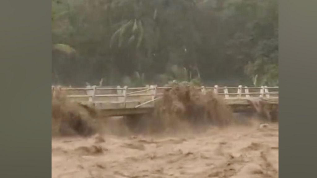 Moment Indonesian river overflows from heavy rain