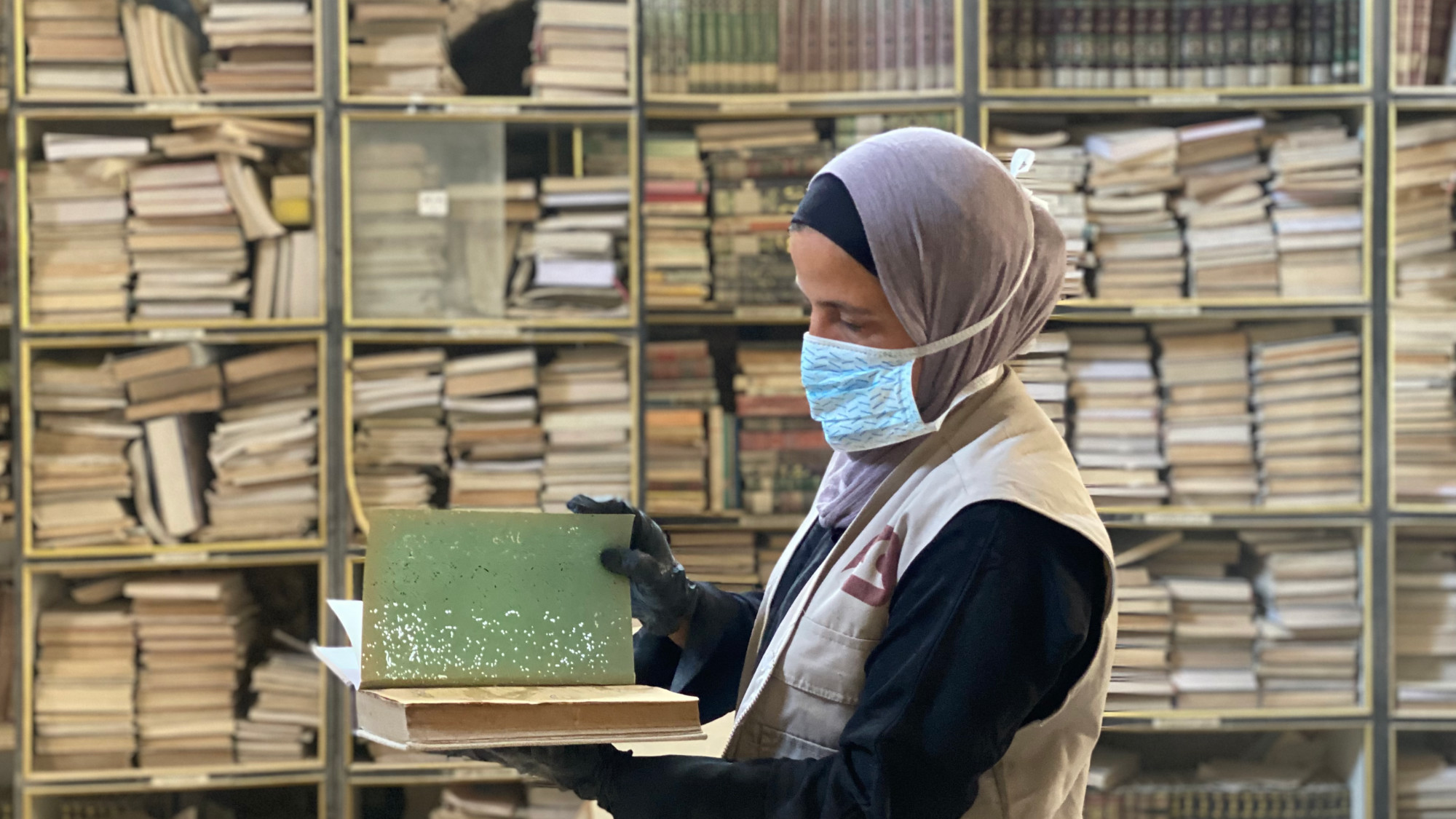 Under rubble and rain, Gaza women try to save rare books in centuries-old library