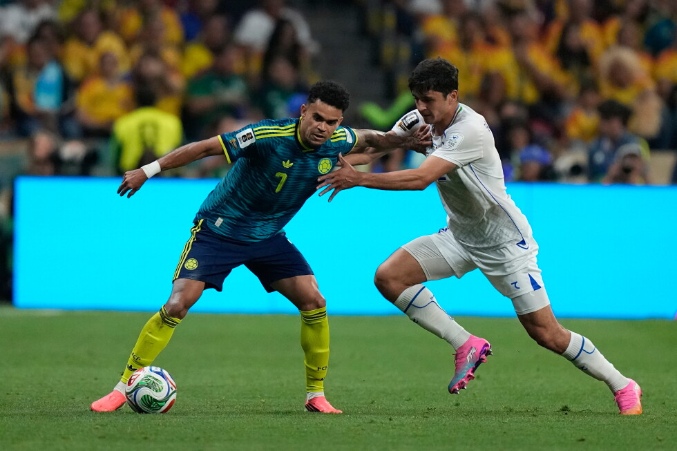 Uzbekistan’s Abdukodir Khusanov collides with a camera operator in World Cup match vs. Colombia