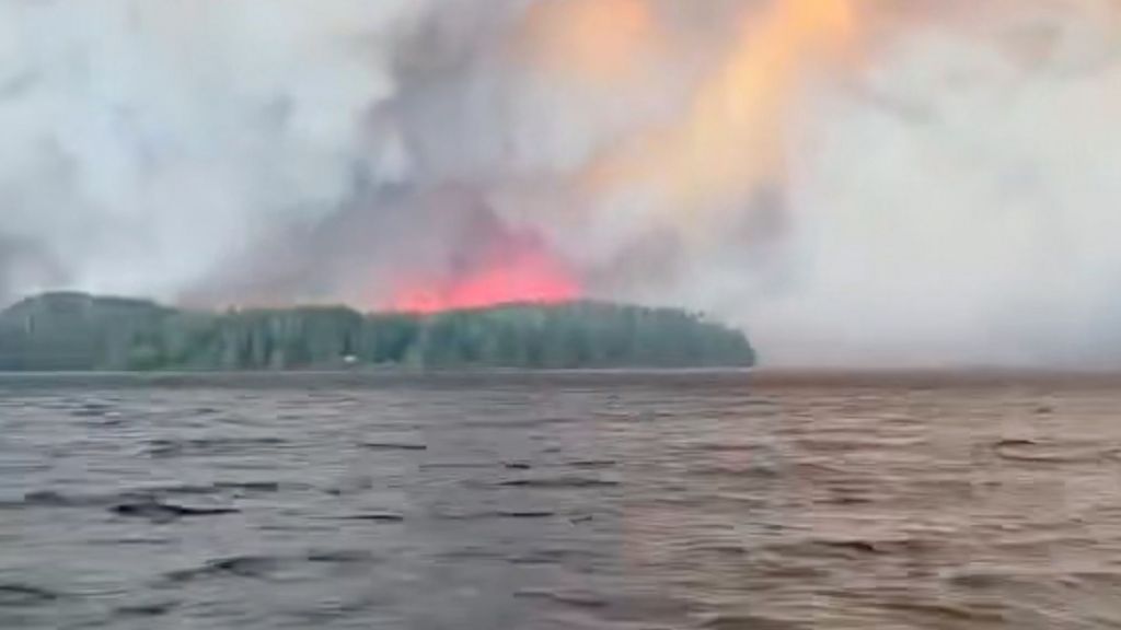 Watch: Residents flee massive Canadian wildfire by boat