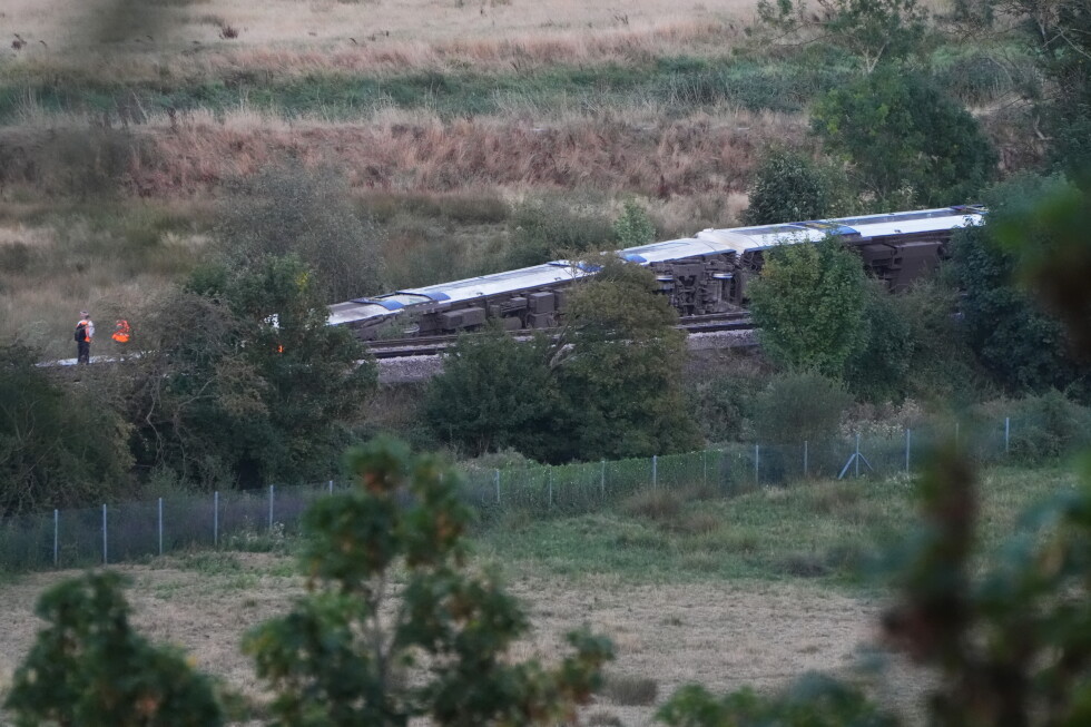 Passenger train derails and 11 people injured after carriages overturn in southern England
